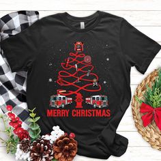 a christmas tree with firetrucks on it and the words merry christmas shirt