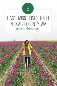 a woman standing in the middle of a field with pink tulips and text overlay