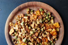 a wooden plate filled with food on top of a table