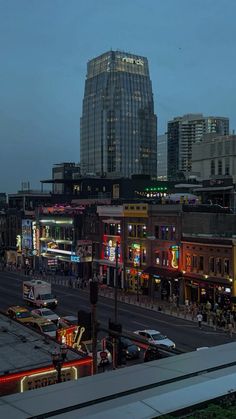 the city is lit up at night and it's lights shine brightly on the buildings