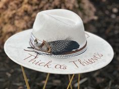 Lainey Wilson - Thick as Thieves - Custom hand burned wide brimmed cowgirl hat made to order just for you.  Colors: Cream Sand (Light Tan) Cognac (Dark Tan) When my dad passed away, I made my mom a hat to commemorate him... with places they've traveled, songs they sung, and things that reminded her of him. I loved it so much, I made myself one with my moms favorite Bible verse, my dads ammo casing and so many things I cherish. When I posted them to my friends, I started getting others wanting a Lainey Wilson Cowboy Hat, Laney Wilson Hats, Handmade Fitted Fedora For Country Events, Custom Fedora For Fall Country Events, How To Start A Hat Bar, Cow Hyde, Burned Hats, Thick As Thieves, Girls Crafts