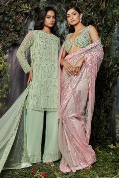 Pink and green ombre net saree with cutdana and tikki hand embroidery. Comes with a blouse.
Components: 2
Pattern: Hand embroidered
Type Of Work: Cutdana, Tikki
Neckline: Sweetheart
Sleeve Type: Sleeveless
Fabric: Net
Color: Pink, Green
Other Details: 
Heavily embriodered blouse
Note : Outfit worn by the model on the left is not for sale.
Occasion: Wedding - Aza Fashions Green Sequined Traditional Wear For Eid, Party Wear Green Dupatta With Mirror Work, Green Cutdana Traditional Party Wear, Green Bollywood Traditional Wear With Sequins, Party Wear Green Georgette Saree, Green Georgette Party Wear Saree, Green Georgette Saree For Party Wear, Green Tissue Silk Sharara For Party, Green Cutdana Dupatta For Party