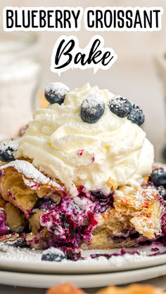 blueberry croissant bake on a plate with powdered sugar and berries