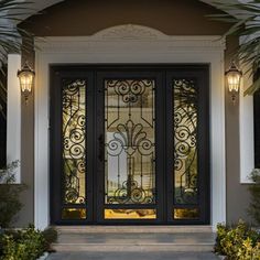 the front door is decorated with glass and palm trees