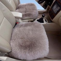 the interior of a car with sheepskin seats and steering wheel covers in grey color