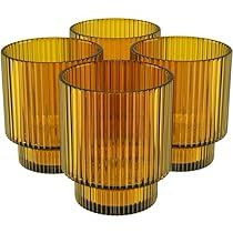 four yellow glass vases sitting next to each other