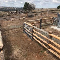 the fence is made of wood and has metal bars on it, along with other fences