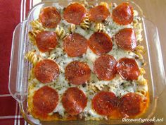 a pizza casserole with cheese and pepperoni in a glass dish on a table