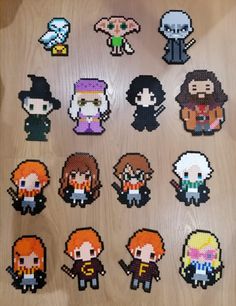 the pixel characters are displayed on a wooden surface with other pixel characters in front of them