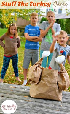 a group of children standing around a bag on top of a wooden table