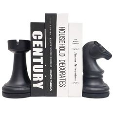 a black chess set sitting next to two books