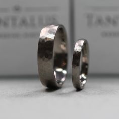 two wedding rings sitting next to each other