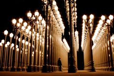 a person standing in front of many street lights