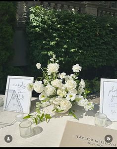 the table is set with white flowers and place cards