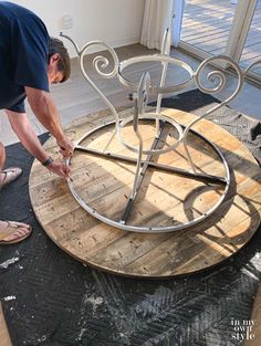 a woman is working on a table made out of wood and metal