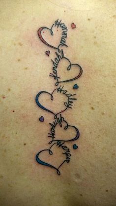 the back of a woman's neck with three hearts on it and words written in cursive writing