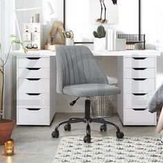 a white desk with drawers and a chair in front of it on top of a rug