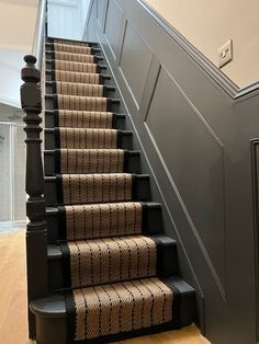 a staircase with carpeted steps and black railing