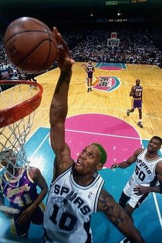 an image of a basketball game being played on the court with other players in the background