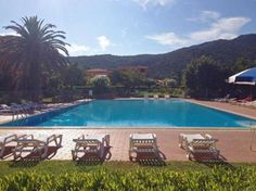 an empty swimming pool surrounded by lawn chairs