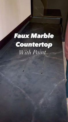 a person standing in front of a counter with the words faux marble countertop with paint