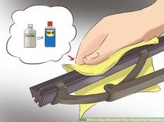 a person is cleaning the back of a bench with a yellow cloth and spray bottle