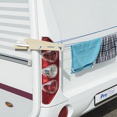 the back end of a camper with towels hanging from it