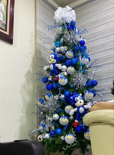 a decorated christmas tree with blue and silver ornaments