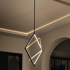 a modern light fixture hanging from the ceiling