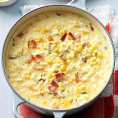 a pot filled with macaroni and cheese soup on top of a red napkin