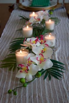 some white flowers and candles on a table