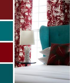 a bedroom with red and white curtains, blue bedding, and a teal chair