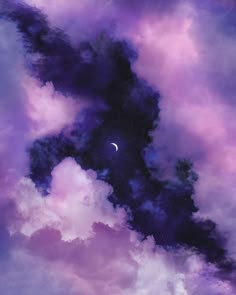 the sky is filled with purple clouds and a half moon in the distance, as well as some dark blue hues