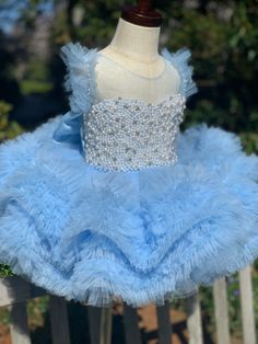 The listing dress is Blue! Blue=Baby Blue=Light Blue=Sky Blue This gorgeous baby dress fully handcrafted with love for your little princess' on special occasion, birthday, or wedding! Gorgeous hand-beaded pearls meets with finest and softest tulle along with layers and tiered ruffles. Rhinestones and pearls makes it more classy and elegant! The dress is knee length and comes with ✩FREE✩ headpiece to match! SIZE 1 and SIZE 2 READY TO SHIP! Please contact us for any size, color and style you may n Sleeveless Ruffled Tutu Dress For Baptism, Princess Style Baptism Dress For Summer Pageant, Tulle Baptism Dress With Ruffles For Pageant, Summer Baptism Dress For Pageant With Tulle Material, Summer Baptism Dress For Pageant In Tulle, Summer Pageant Tulle Baptism Dress, Summer Baptism Dress For Pageants With Tulle Material, Cute Tulle Baptism Dress With Ruffles, Blue Pearl Dress