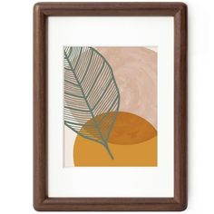 a framed art print with a palm leaf on the left and an orange circle on the right