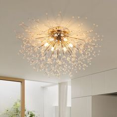 a modern chandelier in the middle of a room with white walls and flooring