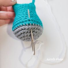 a crocheted purse being worked on with scissors