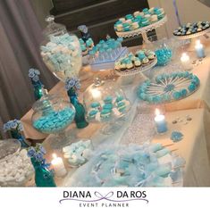 a table topped with blue and white desserts