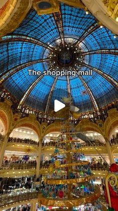 the inside of a shopping mall filled with lots of glass and metal ceilinging,