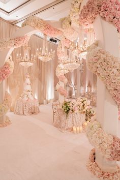 an elegant wedding setup with flowers and chandeliers