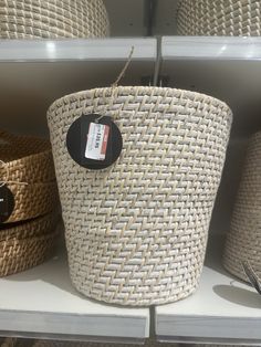 baskets are on display in a store with tags hanging from the top and bottom of them