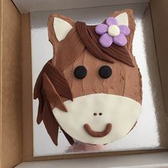 a cake shaped like a horse in a box