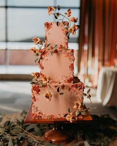 a three tiered cake with flowers on it