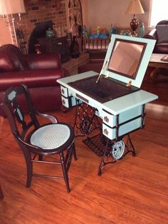 an open laptop computer sitting on top of a table in a living room next to two chairs