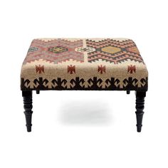 a foot stool with an intricate design on the top and bottom, sitting in front of a white background