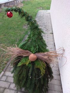 a christmas tree made out of branches and eggshells on the side of a building