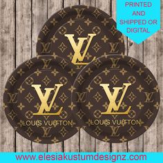 three louis vuitton paper plates on a wooden table