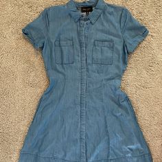 Nwot - Never Worn Beautiful A-Line Silhouette Denim Dress! Button Up Front With Denim Flap Covering The Buttons. Has 2 Side Pockets! Super Soft Material. Size M 100% Lyocell Approximate Measurements: Waist 28” Length ~33” Comment Any Questions And Feel Free To Make An Offer! Medium Wash Cotton Dress With Buttoned Pockets, Spring Denim Blue Dresses With Buttoned Pockets, Medium Wash Summer Dress With Buttoned Pockets, Spring Denim Blue Dress With Buttoned Pockets, Short Sleeve Chambray Dresses With Pockets, Chambray Short Sleeve Dress With Pockets, Denim Blue Cotton Dresses With Buttoned Pockets, Blue Cotton Denim Dress With Buttoned Pockets, Denim Blue Cotton Dress With Buttons