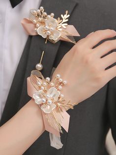 a close up of a person wearing a suit and tie with pearls on it's wrist