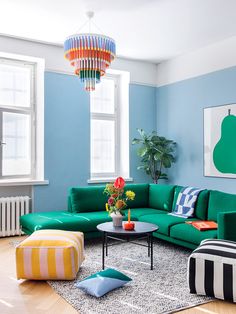 a living room with blue walls and green furniture in the center, on instagram